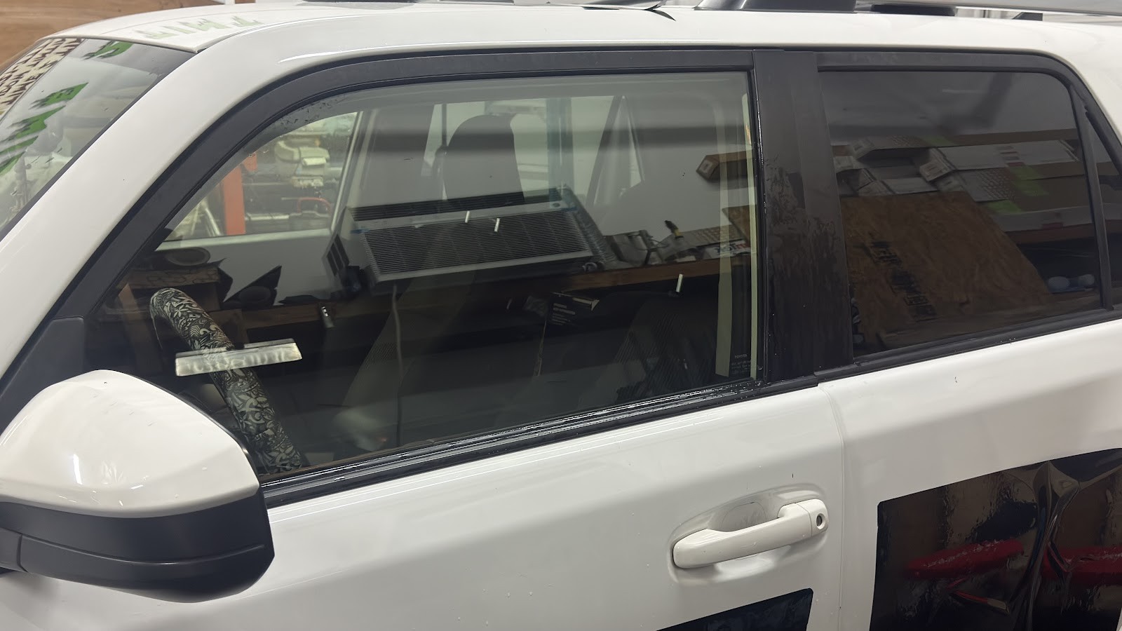 White Toyota 4Runner with tinted rear passenger windows in the shop